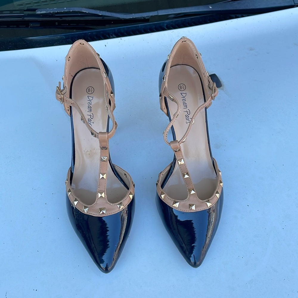 Navy blue with tan and the studs are gold